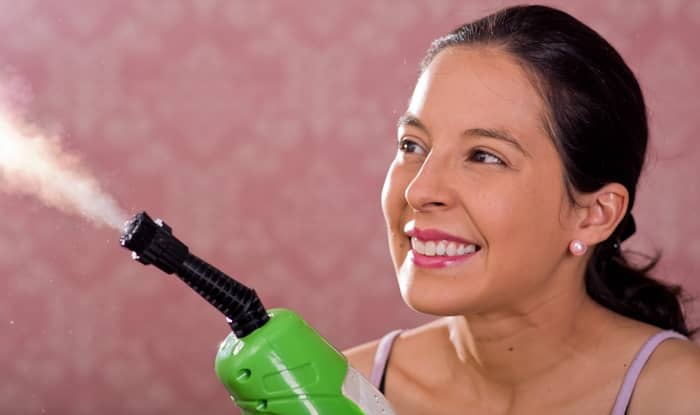 Woman with steam cleaner machine